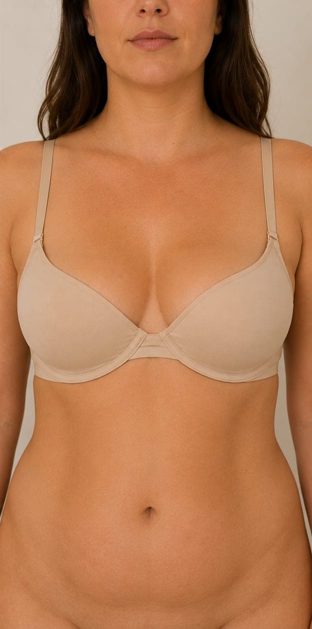 Woman in a nude bra, front view, illustrating breast reduction