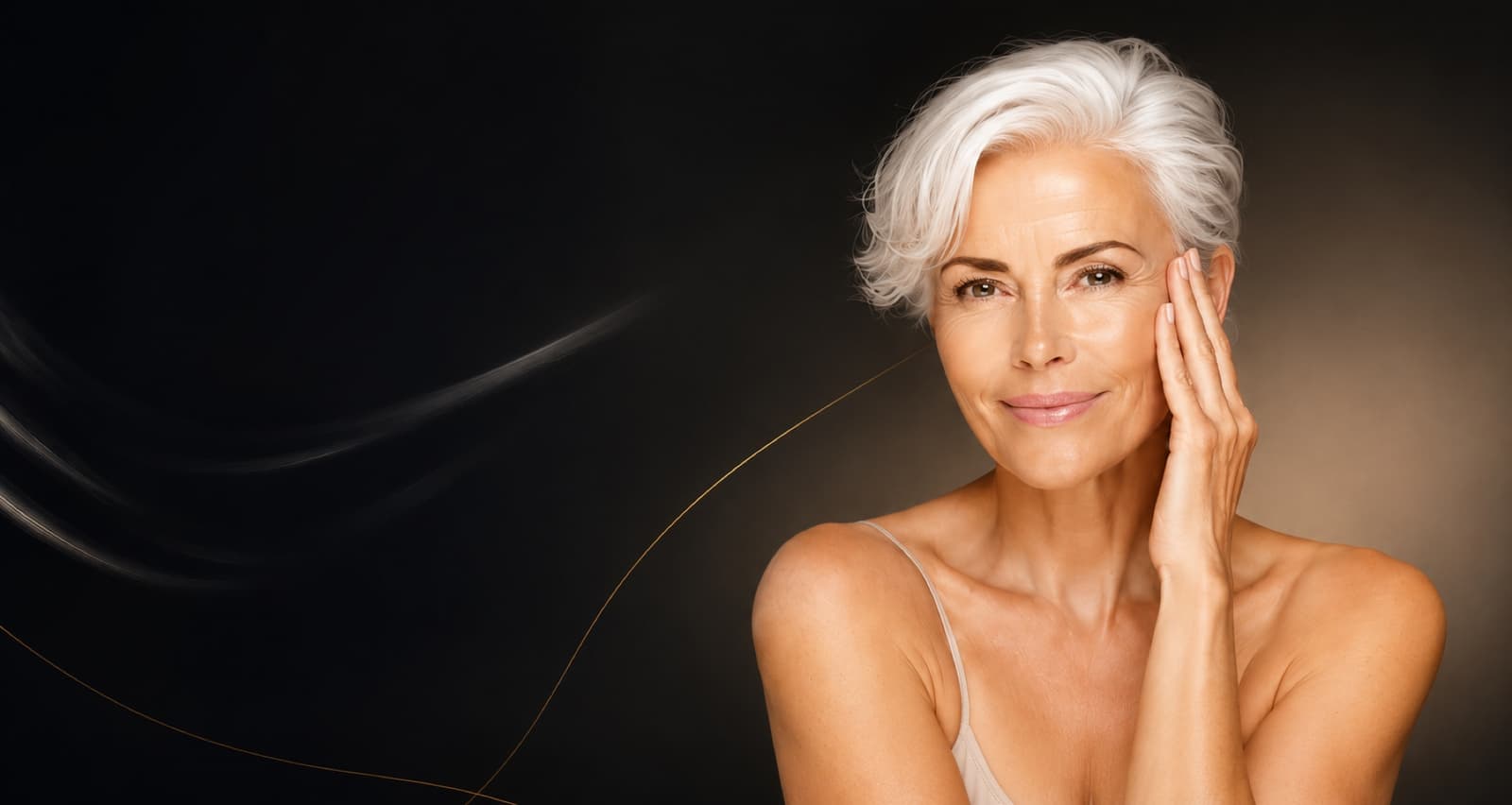 Smiling woman with short silver hair resting her hand against her cheek